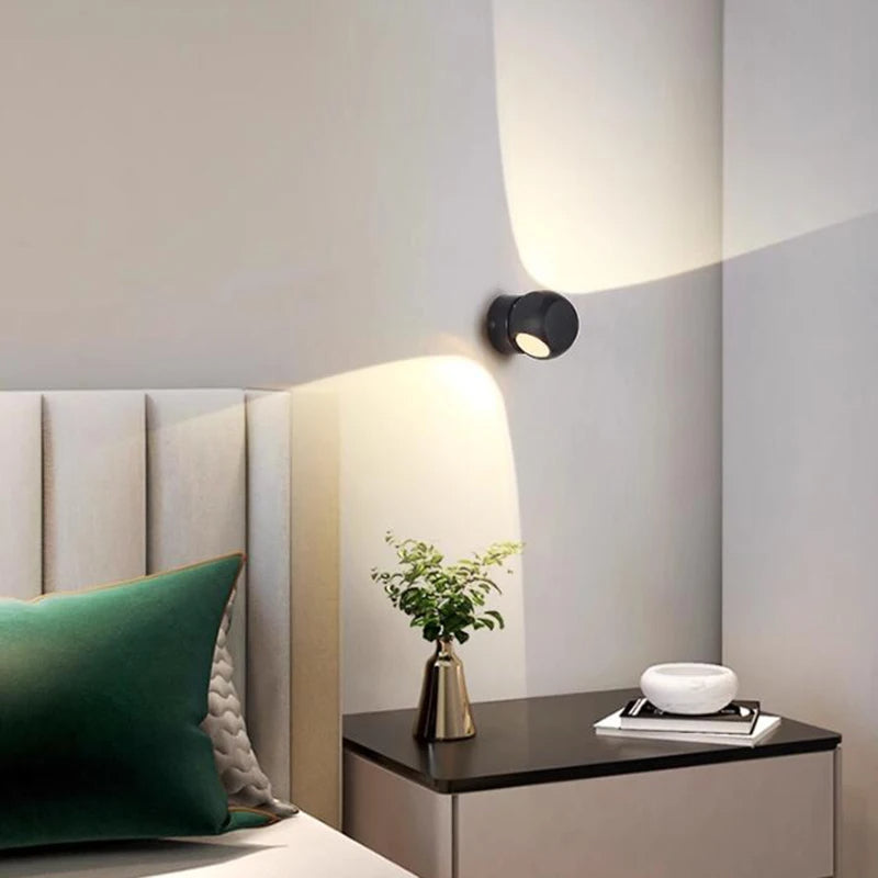 Modern wall light fixture on a neutral wall with decorative elements.