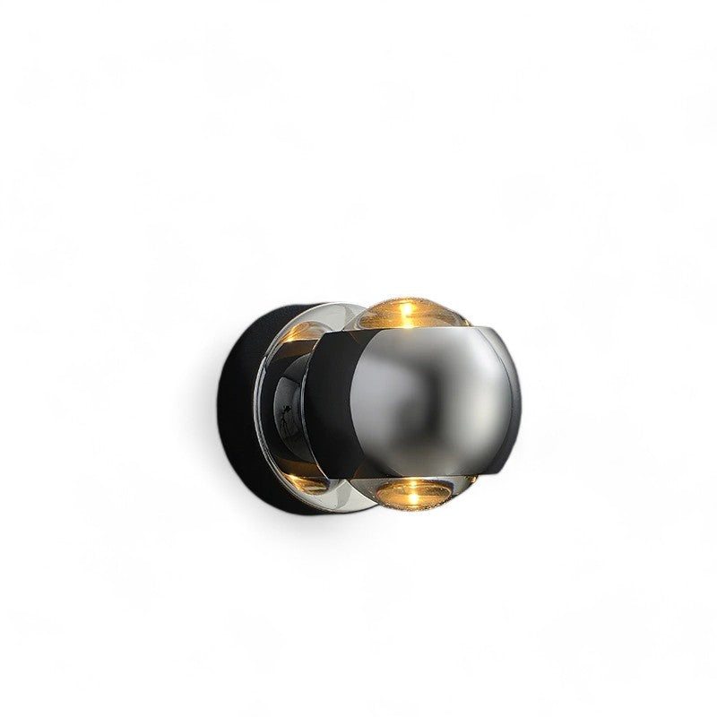 Modern wall light fixture with metallic finish on a white background