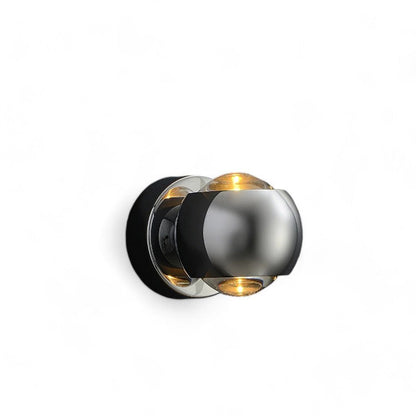 Modern wall light fixture with metallic finish on a white background