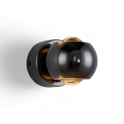 Modern wall light fixture with black and gold design on a white background