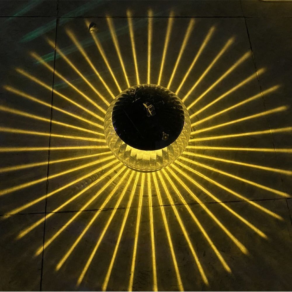 Ceiling light fixture casting a circular yellow pattern on a tiled ceiling