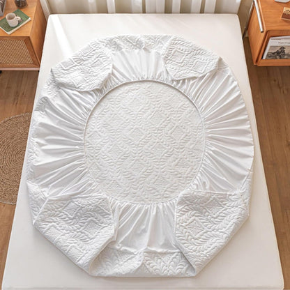 White fitted sheet on a bed in a bedroom setting