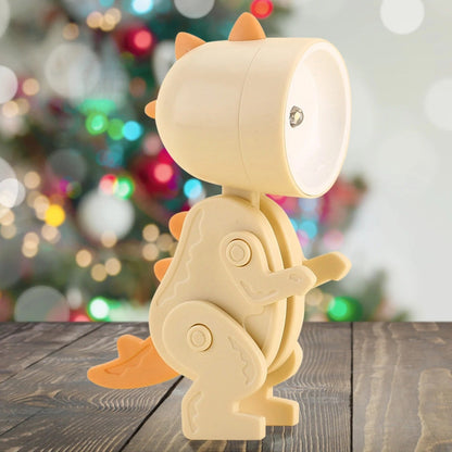 Children's dinosaur lamp on a wooden surface with a blurred festive background