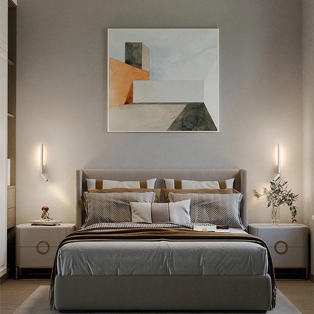Modern bedroom with a bed, nightstands, and abstract art on the wall.