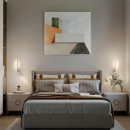 Modern bedroom with a bed, nightstands, and abstract art on the wall.