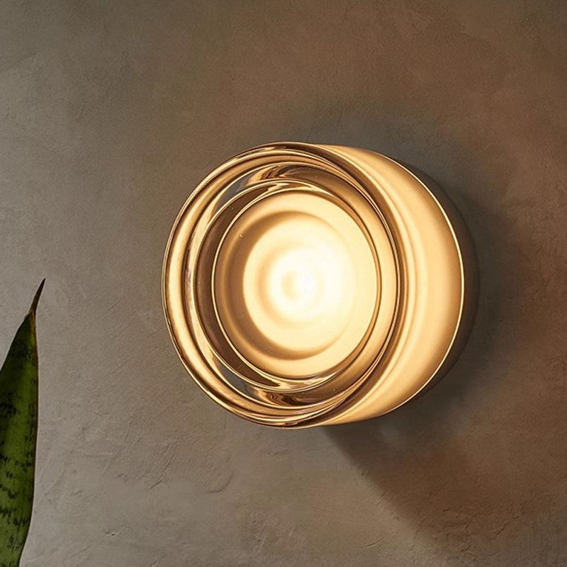 Dimple Round wall light fixture on a textured wall